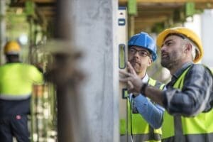 Construction project manager and worker discussing how to do something